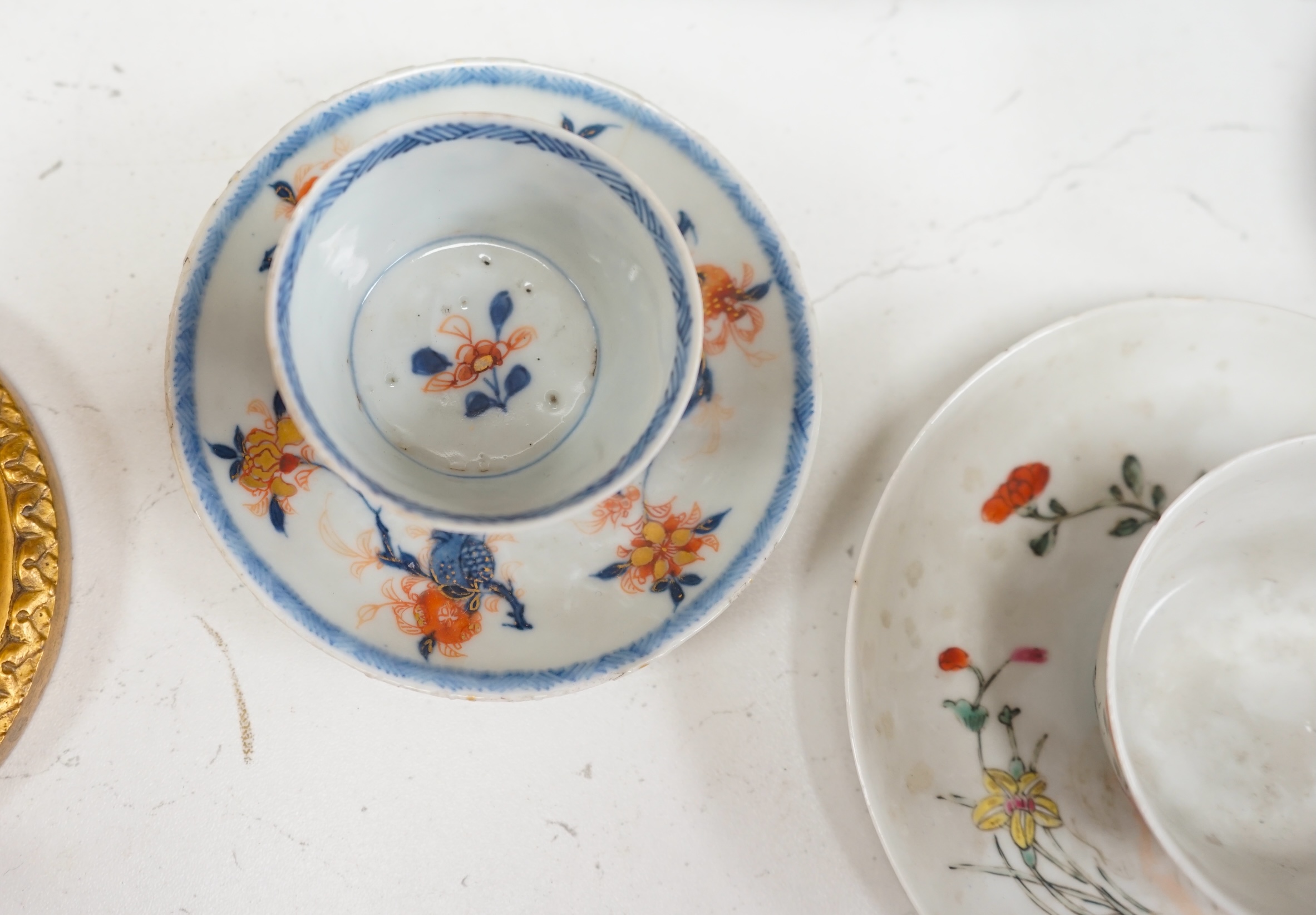 A pair of 18th century Chinese export tobacco leaf pattern pedestal salts, a clobbered Chinese dish (a.f.), now mounted with gilt metal rim, etc., 41cm diameter, together with four 18th century Chinese tea bowls, and thr